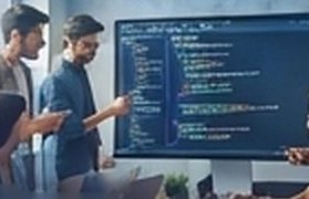 Developers reviewing code on a large screen